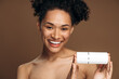 © speed300 - Soft skin. Portrait view of a perfect female with body cream. Woman showing cream or lotion into the camera before the applying moisturizer at her skin