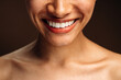 © speed300 - Cropped view of the multiracial woman smiling toothy and posing to the camera while standing in front of the brown wall. Stock photo