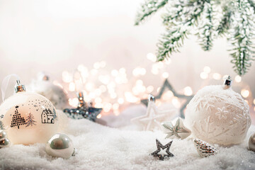 christmas white decorations on snow with fir tree branches and christmas lights. winter decoration b