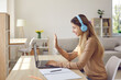 © Studio Romantic - Smiling girl student in headphones talk on video call on computer, have online lesson. Happy woman in earphones speak on webcam digital event, study distant laptop on lockdown form home.
