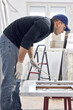© astrosystem - Young adult man painting on a DIY budget renovation of his new home apartment.