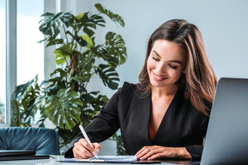 Canvas Print - Businesswoman wearing formal suit is taking notes signing contract