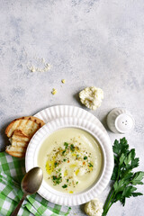 Wall Mural - Cauliflower creamy soup with potatoes and cheese. Top view with copy space.