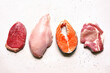 Different types of organic raw meat : beef, chicken, fish and pork. Source of protein. Top view .