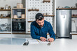 © Srdjan - Young freelancer businessman planning and organizing business from his home. Creative man standing in the kitchen getting ideas and solutions for new project.