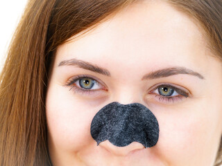 Wall Mural - Woman applying pore strips on nose