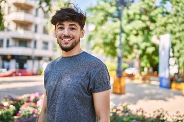 Young arab man smiling happy standing at the city.