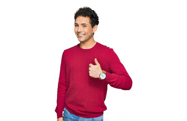 Young handsome man wearing casual clothes doing happy thumbs up gesture with hand. approving expression looking at the camera showing success.