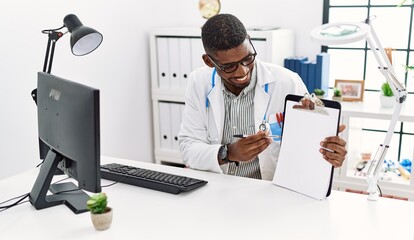 Sticker - Young african american man wearing doctor uniform working at clinic