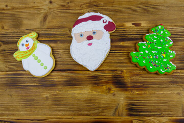 Wall Mural - Christmas gingerbread cookies on a wooden table. Top view