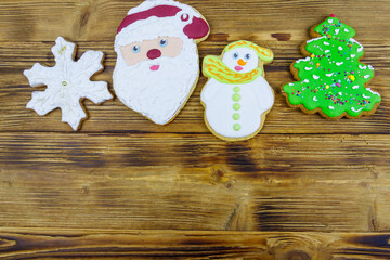 Wall Mural - Christmas gingerbread cookies on a wooden table. Top view, copy space