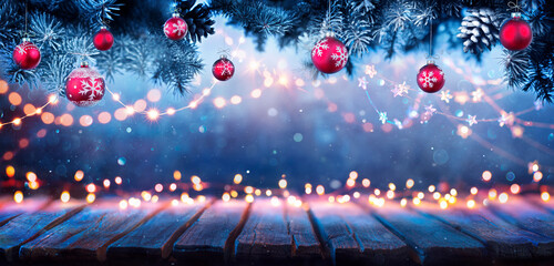 Wall Mural - christmas table - lights and ornaments with fir branches at night - abstract defocused elements