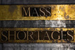 © IHX - Mass Shortages text on vintage textured grunge copper and gold background