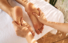 Foot Massage With Massage Oil For Male Feet While Relaxing And Resting At Spa. Legs Massage For Man