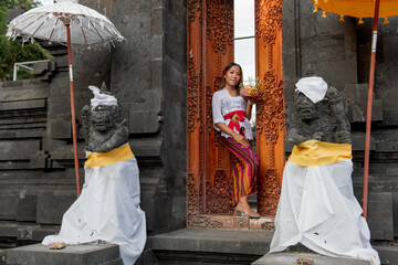 Local girls in traditional clothing, Pura Candidasa is a gorgeous Hindu temple, Bali.