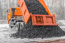 Dump Truck In The Industrial Zone Unloads Coking Coal From The Body