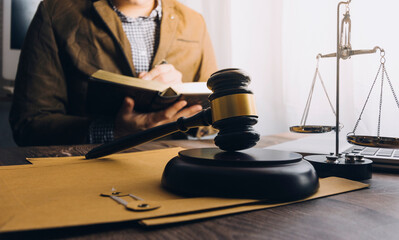 Business and lawyers discussing contract papers with brass scale on desk in office. Law, legal services, advice, justice and law concept picture with film grain effect