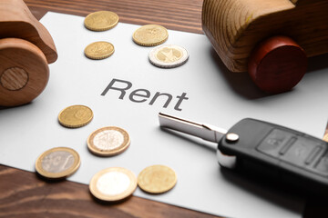 Poster - Paper with word RENT, cars, coins and key on wooden background