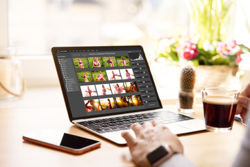 Wall Mural - Woman editing digital photos on laptop computer
