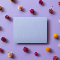 Wall Mural - Blank memo paper with dry flowers on purple background. top view, copy space