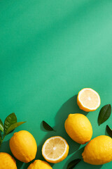 Wall Mural - Lemon and green leaf in a green background with blank space , front view , for advertising 