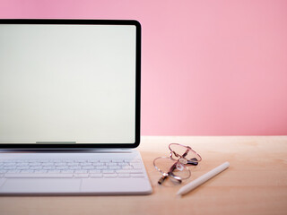 Wall Mural - a minimalistic workplace for a designer, developer or other freelancer. a white thin laptop with a w