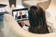 © Jacob Lund - Rearview of a businesswoman attending a video conference in an office