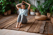 © muse studio - Fitness at home break sports. Instructor of aerobics and healthy lifestyle. The trainer does yoga asana exercises.