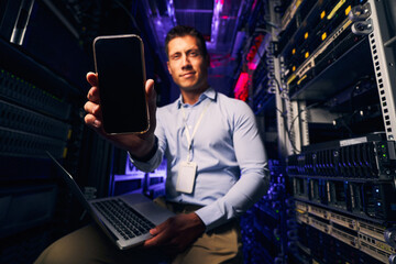 Wall Mural - IT professional posing for camera in server room