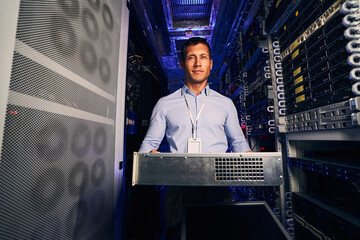 Wall Mural - Tranquil data center engineer installing new hardware component