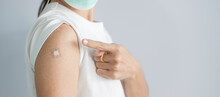Woman Showing Bandage After Receiving Covid 19 Vaccine. Vaccination, Herd Immunity, Side Effect, Booster, Vaccine Passport And Coronavirus Pandemic