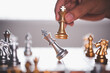 business man hand handle gold king chess eliminate silver chess team