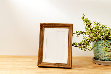 Wall Mural - Blank decorative picture frame on wooden table