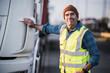 © Westend61 - Smiling male driver standing by truck