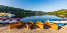 Rowboats And Pedal Boats Left On Shore Of Titisee Lake