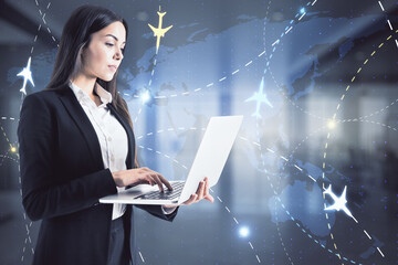 Canvas Print - Attractive young european businesswoman using laptop computer in blurry office interior with glowing airplane connections hologram. Online booking and travel concept. Double exposure.