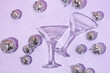 © Adela - Christmas party creative layout with martini  cocktail glasses and disco ball decoration on  pastel purple background. Retro fashion aesthetic party concept. New Year or Christmas idea.