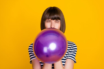 Sticker - Photo of impressed brunette millennial lady blow balloon closed eyes wear blue t-shirt isolated on yellow background