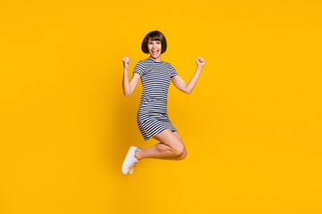 Wall Mural - Full body profile photo of funny young lady jump wear blue dress sneakers isolated on yellow background