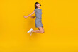 © deagreez - Full length photo of nice brunette millennial lady jump wear dress sneakers isolated on yellow background