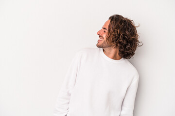 young caucasian man isolated on gray background relaxed and happy laughing, neck stretched showing t