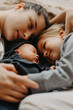 © Ananass - the mother lay down to sleep next to her daughters. Home photo of children with mom who fell asleep hugging