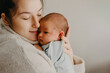 © Ananass - Beautiful woman holds a newborn baby in her arms