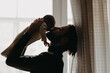 © Ananass - Beautiful bearded father kisses newborn daughter in a dark room near the window