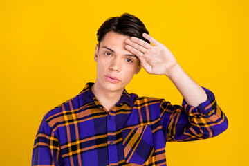 Sticker - Photo of tired upset teen boy wear plaid outfit hand forehead isolated yellow color background