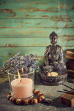 Fototapeta Desenie - Spiritual still life with candles, beads, statue of Buddha and dry flowers