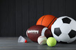© New Africa - Set of different sport balls and shuttlecock on grey wooden table