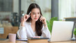 © amnaj - Beautiful young Asian businesswoman charming talking on the mobile phone in the office.