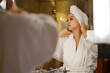 © ABWitzPix089 - Asian young woman in a bathrobe and hair wrapped in towel looking at the mirror in the bathroom