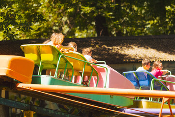 Wall Mural - The confused kids ride a roller coasters for the first time